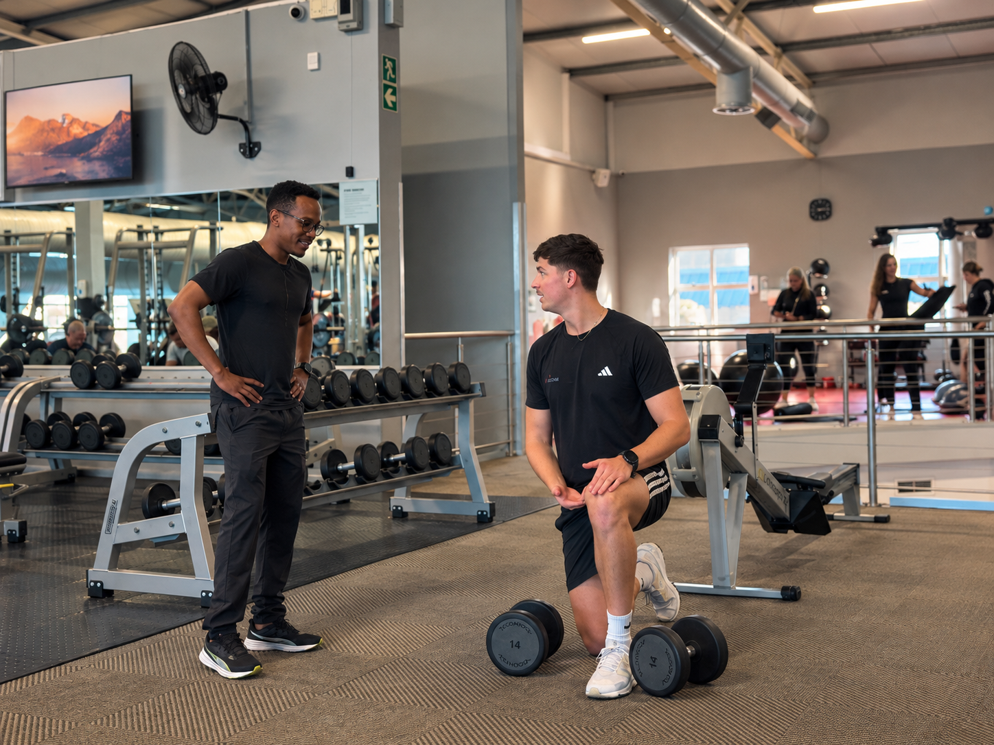 Ian Orban coaching a client in the gym in Table View